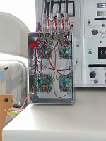  A closer view of the 4 Softrock v6 receivers and the DDS-60 oscillator.  The red clip lead supplies DC to activate the reversing relays to which the array from east to west.